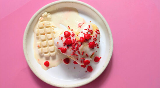 Top view of Mini Coconut Heart Cakes topped with candied hearts and sprinkles. Photo by Charles Malene for MoodyEater™