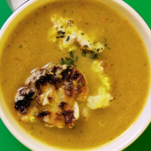 Révolution Réchauffé 02: Close-up shot of Apple Pumpkin Soup with Roasted Cauliflower and Sunflower Miso Tahini Dressing. Photo by Charles Malene for MoodyEater™