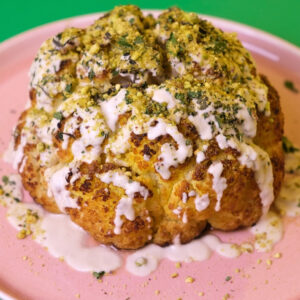 Delicious Roasted Cauliflower with Sunflower Miso Tahini covered in crushed pistachios, mint and parsley. Photo by Charles Malene for MoodyEater™