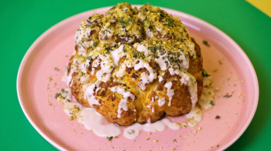 Delicious Roasted Cauliflower with Sunflower Miso Tahini covered in crushed pistachios, mint and parsley. Photo by Charles Malene for MoodyEater™