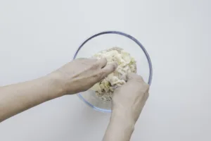 Crumble mix with hands. Photo by Charles Malene for MoodyEater™