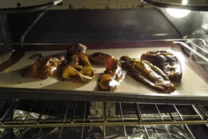Roasted sweet red peppers in the oven. Photo by Charles Malene for MoodyEater™